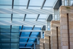 Indoor U-M stock photo of skylight gridded ceiling with brick pillars.