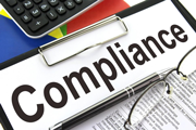 Page with the word Compliance on a desk