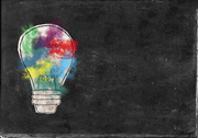 Multi-colored lightbulb on a black background