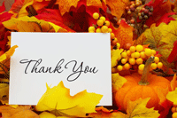 Autumn colored leaves with a thank you note