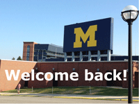 Michigan Stadium overlaid with the words, "Welcome back!"