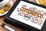 Tablet screen with the word Compliance