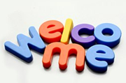 Colorful refrigerator magnets on a white background spelling the word "welcome"